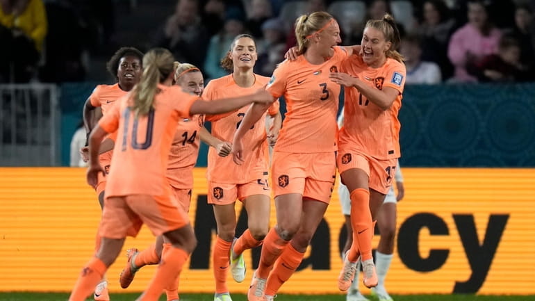 Netherlands' Stefanie Van der Gragt, second right, celebrates with teammates...