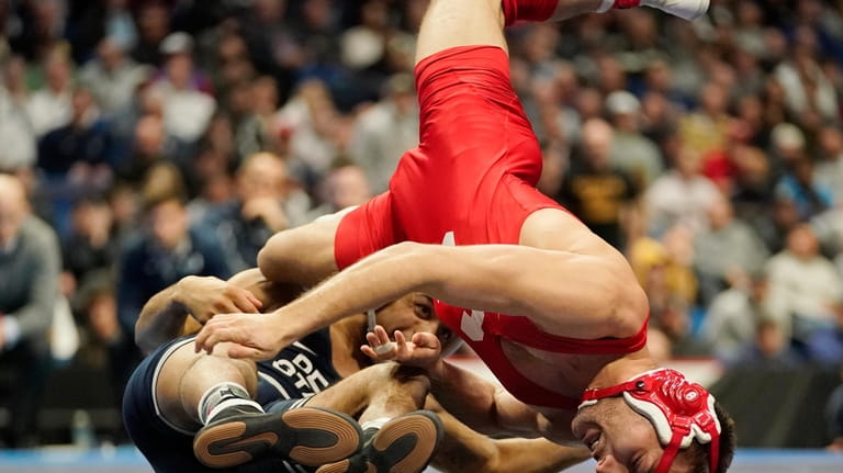 Cornell wrestler Vito Arujau, right, wrestles Penn State's Roman Bravo-Young,...