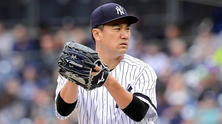 Masahiro Tanaka of the Yankees delivers the pitch against the...