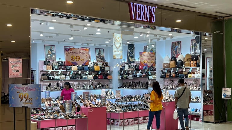 People shop at a Vern's outlet at a shopping mall...
