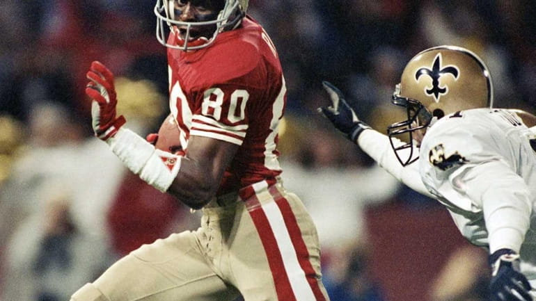 San Francisco 49ers wide receiver Jerry Rice runs past New...