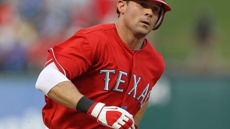 Texas' Michael Young hits a solo home run against the...