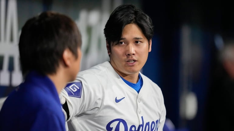 Los Angeles Dodgers' designated hitter Shohei Ohtani, right, chats with...