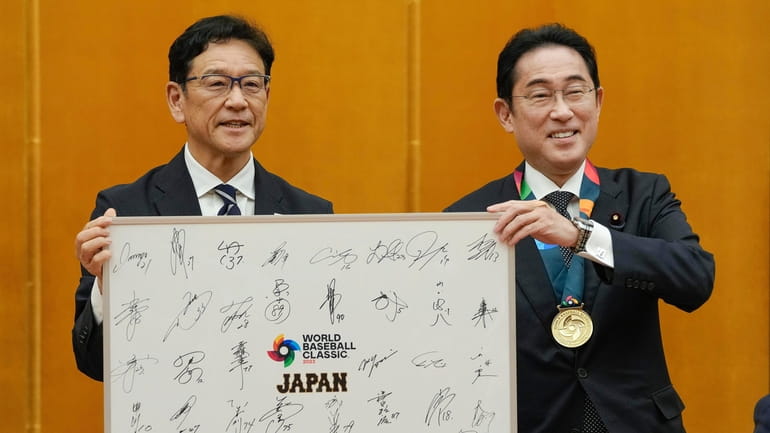 Japan's World Baseball Classic (WBC) team manager Hideki Kuriyama, left,...