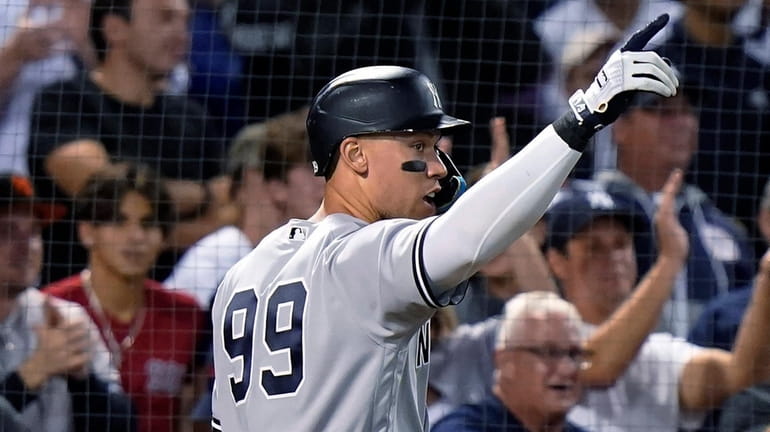 The Yankees' Aaron Judge celebrates after scoring on a three-run...