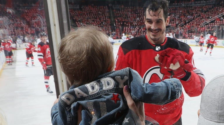 Brian Boyle of the New Jersey Devils waves to his...