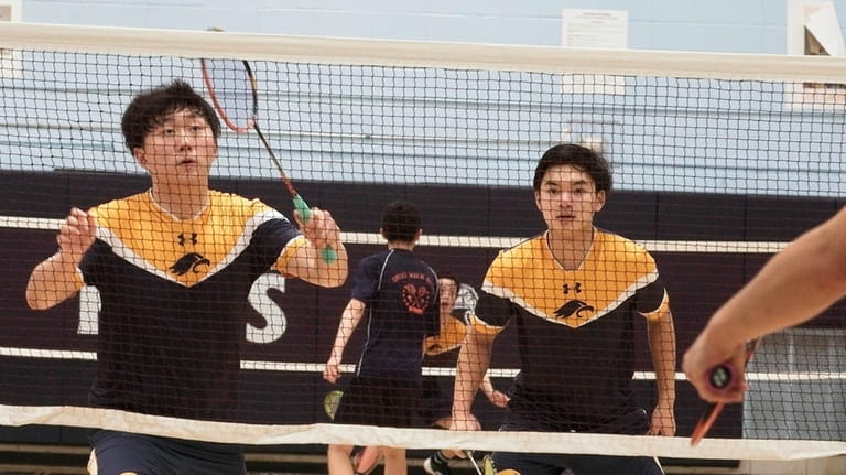 Jericho’s Jerry Zhang (left) and Jonathan Chau win in doubles...