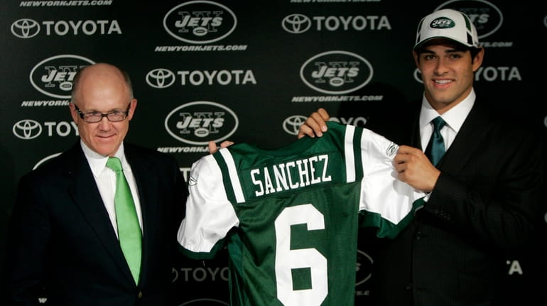 Jets owner Woddy Johnson, left, presents Mark Sanchez with his jersey...