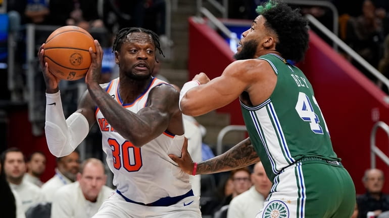 Knicks forward Julius Randle (30) is defended by Detroit Pistons...
