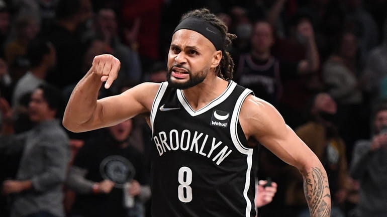 Nets guard Patty Mills reacts when his shot ties the...