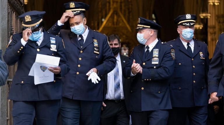 NYPD department members exit St. PatrickÕs Cathedral Monday, Oct. 5,...