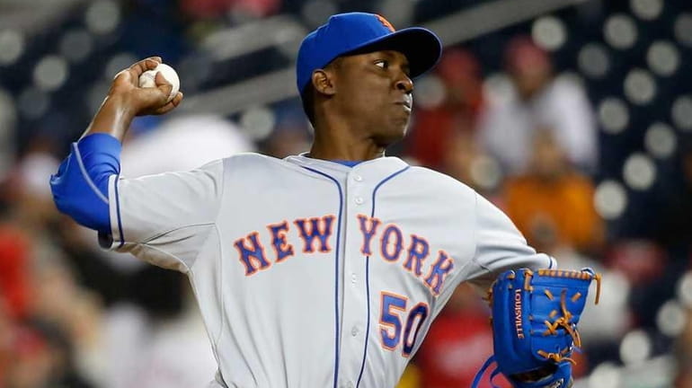 Pitcher Rafael Montero of the New York Mets throws to...
