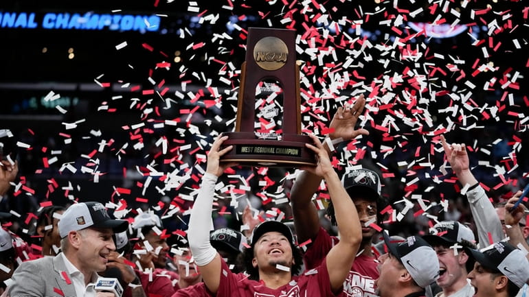 Alabama guard Mark Sears holds the winner's trophy after defeating...