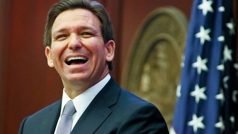 Florida Gov. Ron DeSantis reacts to applause as he gives...