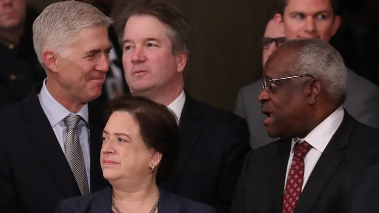 Supreme Court Justices Neil Gorsuch, left, and Clarence Thomas right. , at...