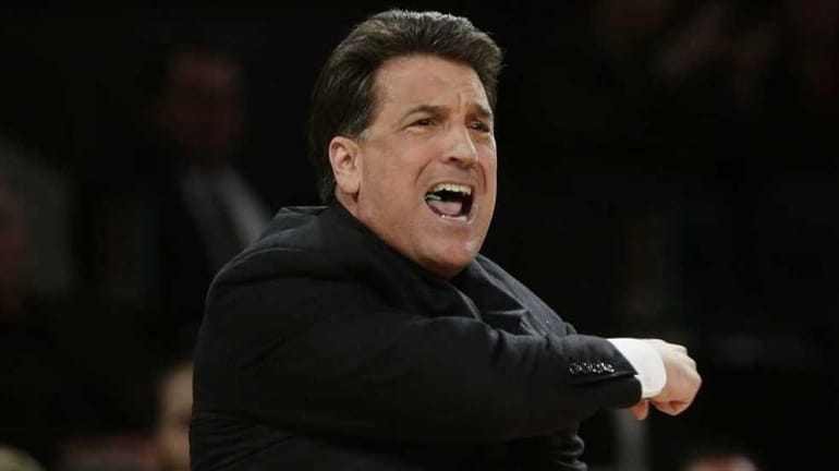 St. John's head coach Steve Lavin calls out to his...