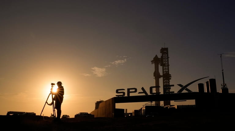 A photographer prepares to makes photos of SpaceX's mega rocket...