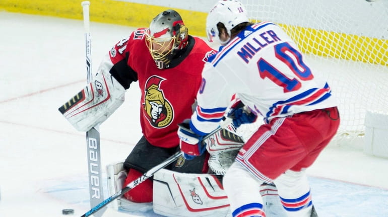 Rangers left wing J.T. Miller tries to tip the puck...