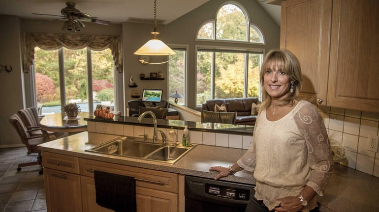 Susan O'Donnell stands in the kitchen of her Medford home....