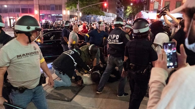 Members of the NYPD detain demonstrators against police brutality sparked...