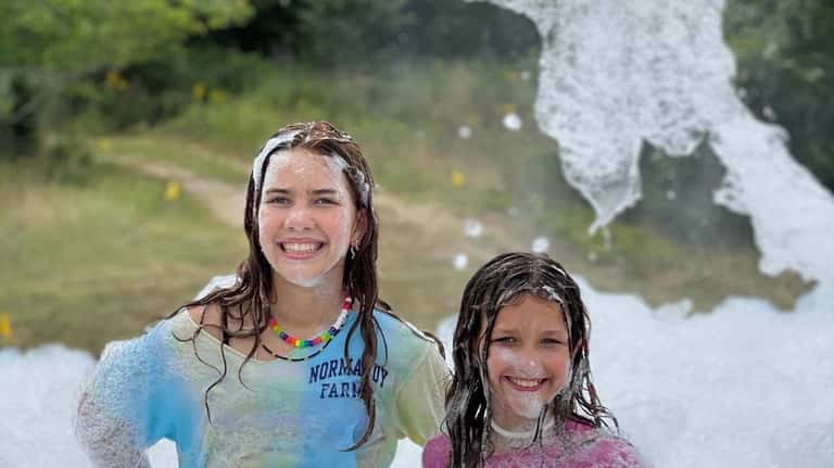 Sisters Molly, 13, and Gemma Parsons, 10, of Baiting Hollow,...