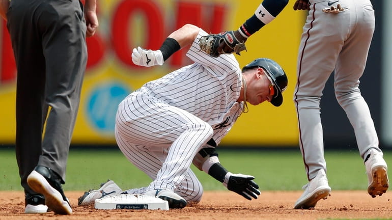 The Twins' Nick Gordon tags out Yankees third baseman Josh Donaldson (28)...