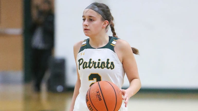 Ward Melville's Julia Greek brings the ball upcourt in the...
