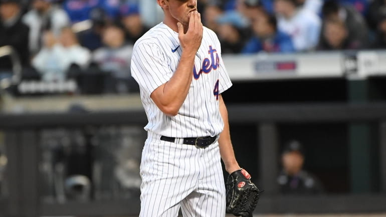 New York Mets starting pitcher Chris Bassitt reacts after the...