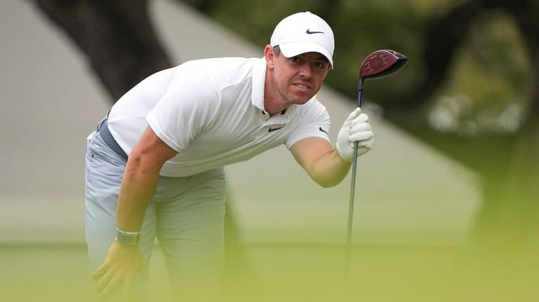 Rory McIlroy, of Northern Ireland, watches his drive on the...