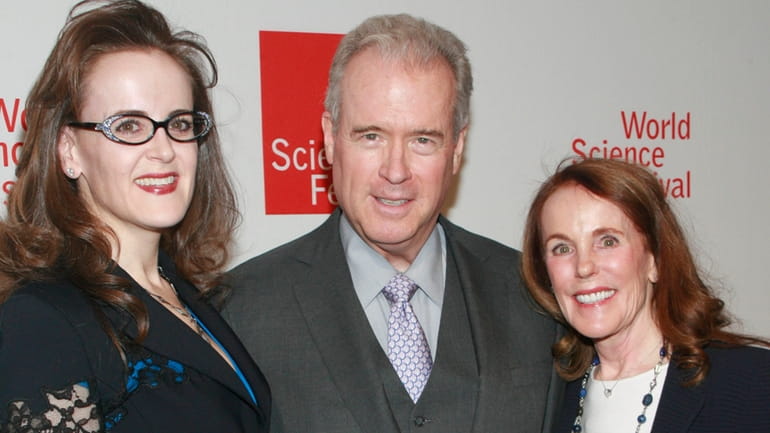 Robert Mercer, center, with his daughter Rebekah, left, and wife...