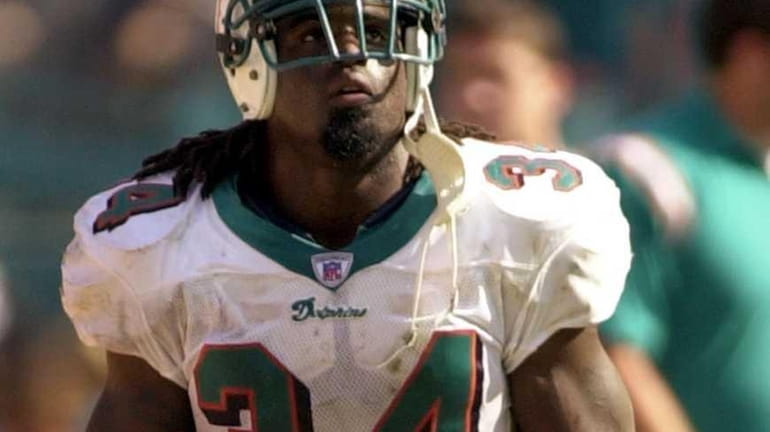 Miami Dolphins running back Ricky Williams looks up at the...