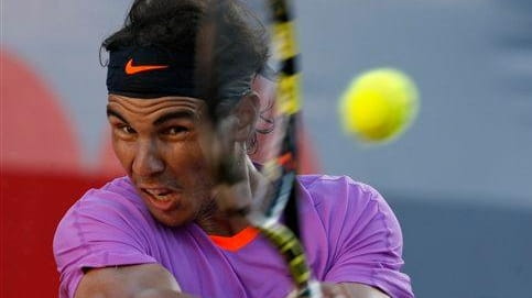 Rafael Nadal returns the ball to Horacio Zeballos during the...