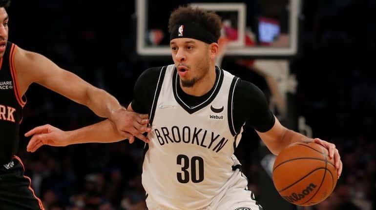 Seth Curry of the Nets drives against Quentin Grimes of...