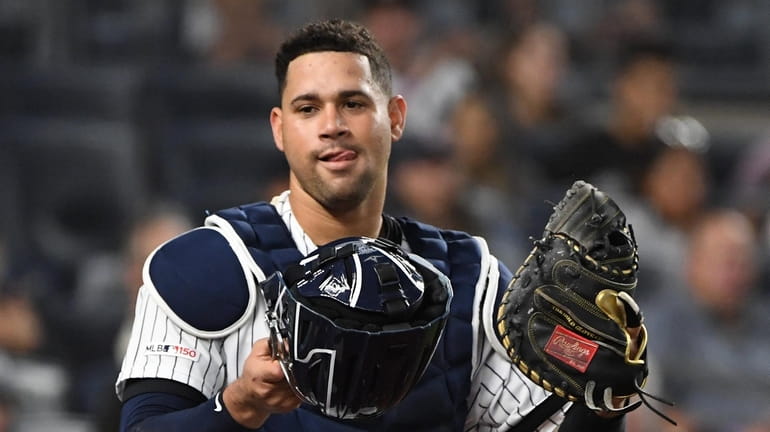 New York Yankees catcher Gary Sanchez looks on after he...