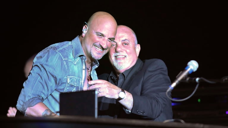 Billy Joel, right, made a surprise appearance at the Paramount...