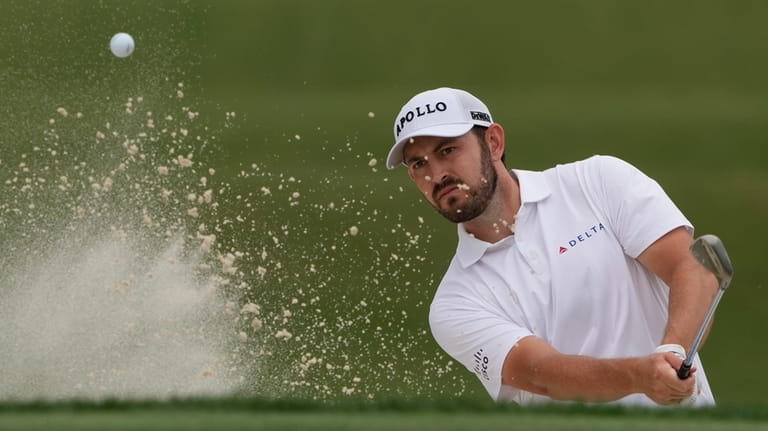 Patrick Cantlay hits from the bunker on the ninth hole...