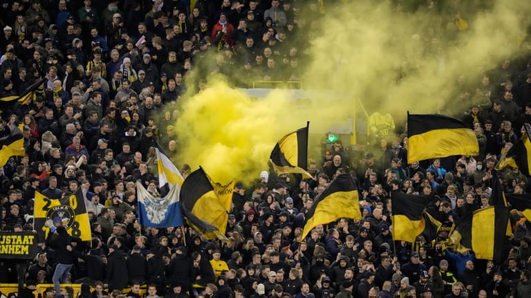 Vitesse fans delay the start of the match as they...