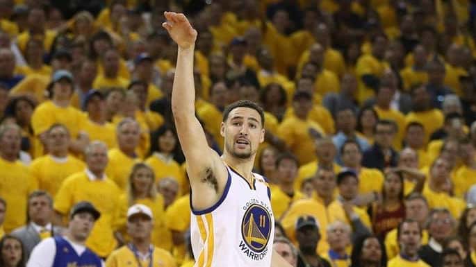 Klay Thompson of the Golden State Warriors watches his jump...