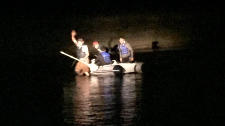 Suffolk County Police Marine Bureau officers rescued four men in...