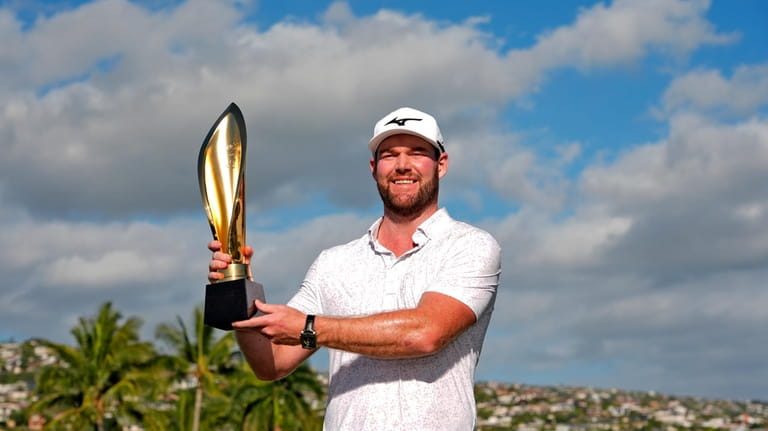 Grayson Murray holds the trophy after winning the Sony Open...