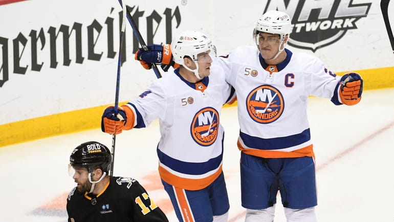 New York Islanders left wing Anders Lee, right, is congratulated by...