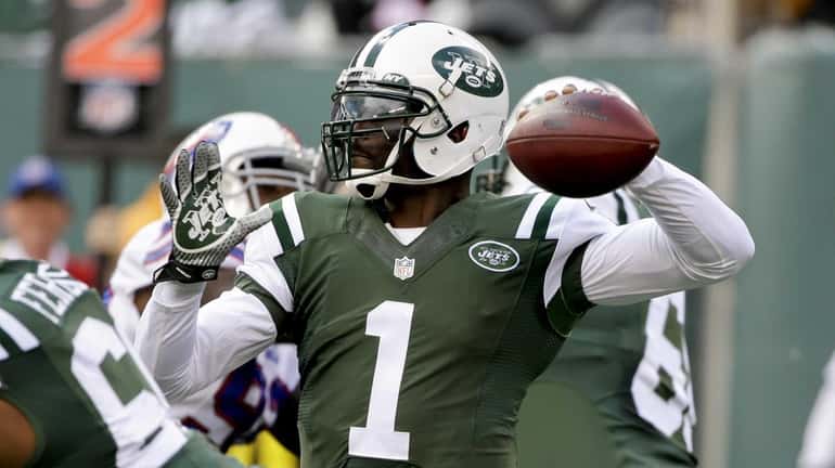 Jets quarterback Michael Vick throws a pass during the first...