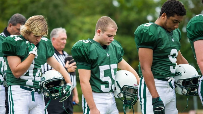 Members of the Locust Valley football team pause for a...