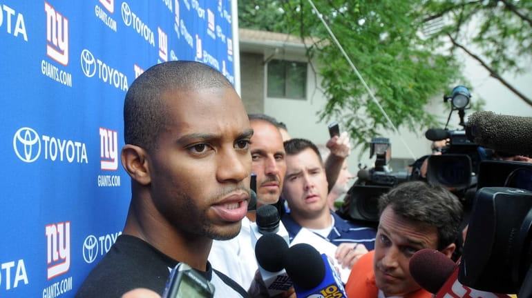 New York Giants receiver Victor Cruz talks with reporters on...