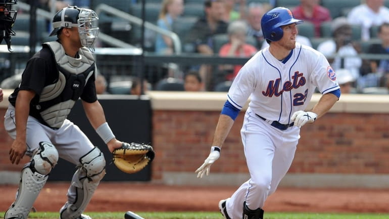New York Mets first baseman Ike Davis (29) doubles in...