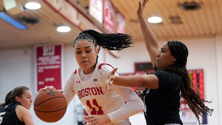 Boston University forward Caitlin Weimar (11) drives toward the basket...
