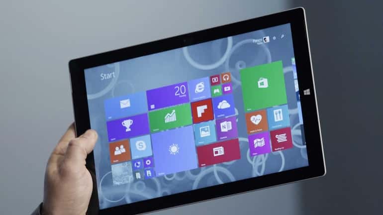 A Microsoft executive shows off the Surface Pro 3 tablet...