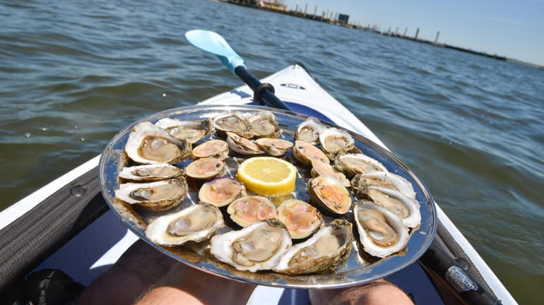 A platter of fresh oysters and clams near the oyster...