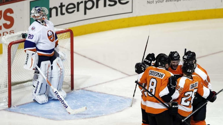 Islanders goalie Evgeni Nabokov watches the replay as Philadelphia Flyers'...