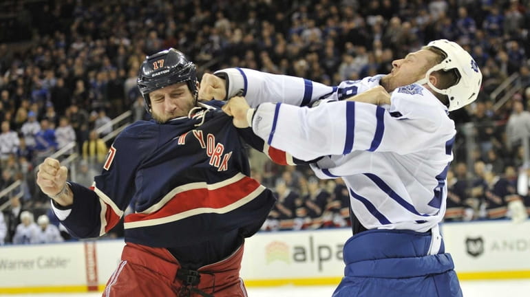 Mike Rupp and Colton Orr of the Maple Leafs fight...